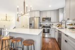 Stone counters and stainless appliances grace this updated space